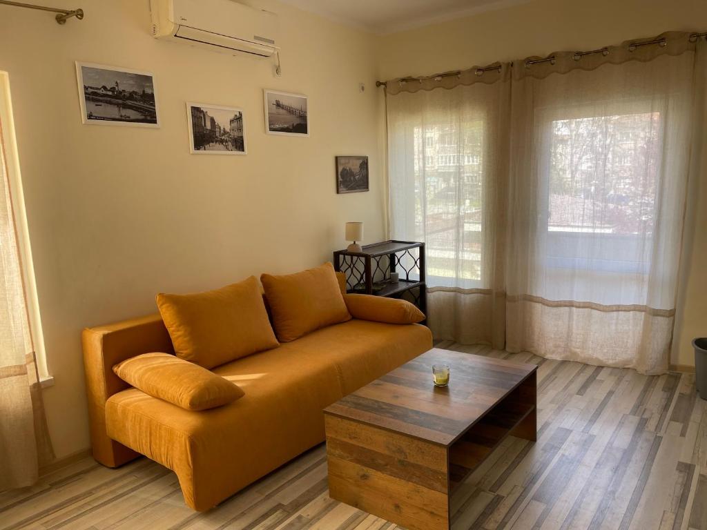 a living room with a couch and a coffee table at Mila 6 in Burgas