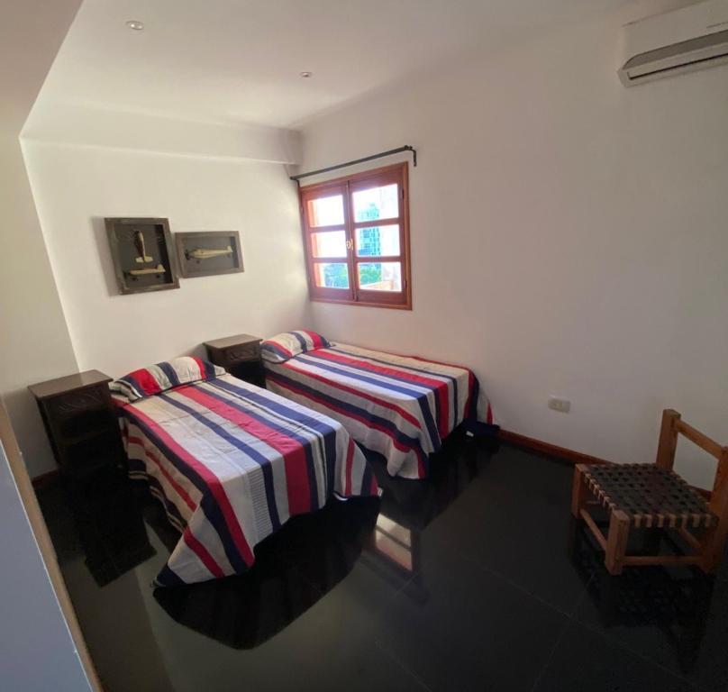 a room with two beds and a window at Arborea in Posadas