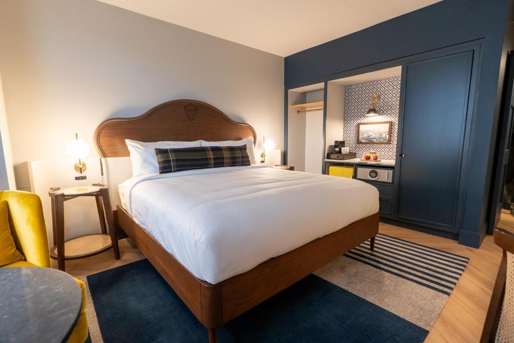 a bedroom with a large white bed and a window at The Hoya Hotel at Georgetown in Washington, D.C.