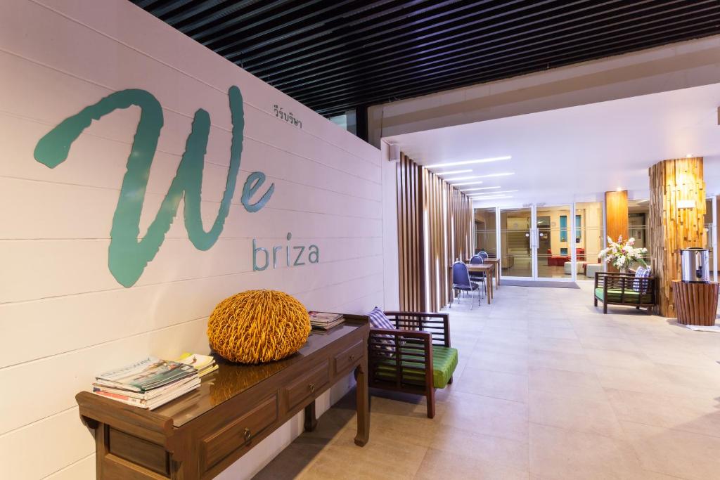A hotel entrance lounge leading toward reception and additional seating.