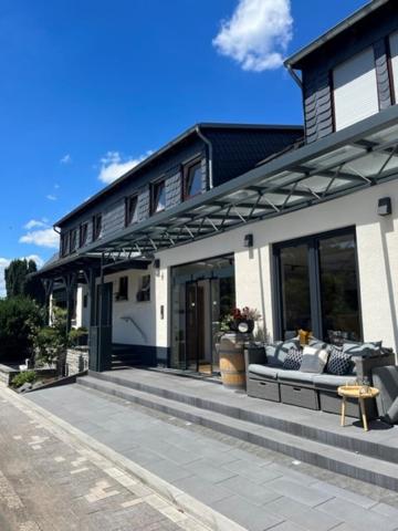 a house with a bench in front of it at Weingut Zenz-Pohl in Kinheim