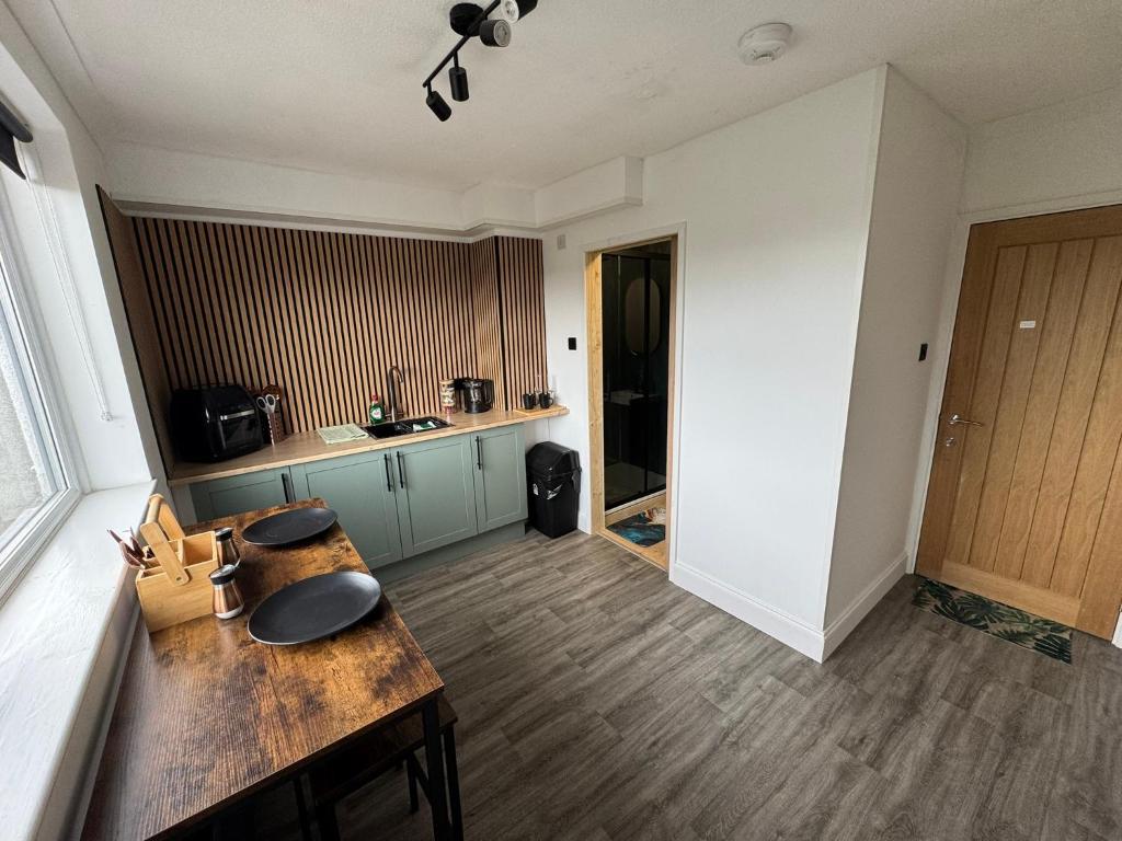 a kitchen with a wooden table in a room at Victoria Park in Bristol