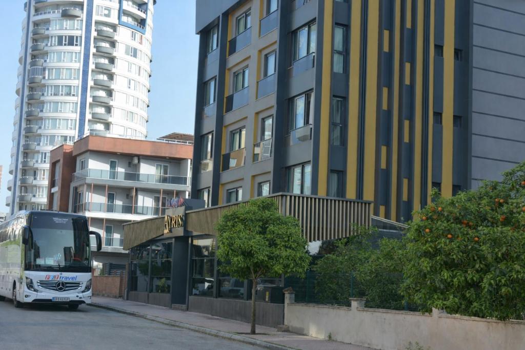a bus is parked in front of a building at Casa Ayris Boutique Hotel in Mersin
