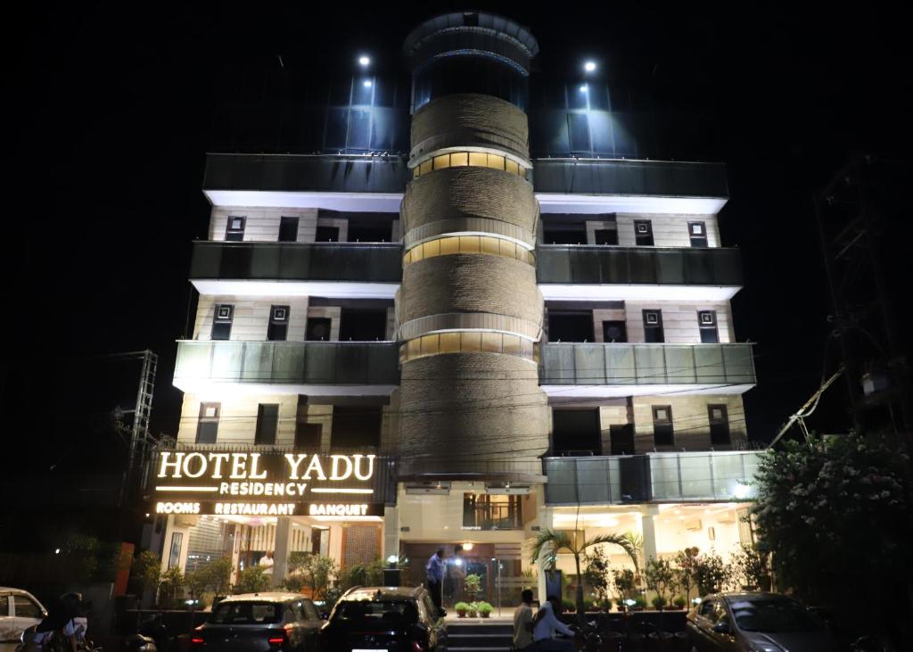 a building with a tower in front of it at Hotel Yadu Residency in Meerut