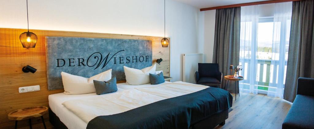 a hotel room with a bed with a sign on it at Der Wieshof in Riedlhütte