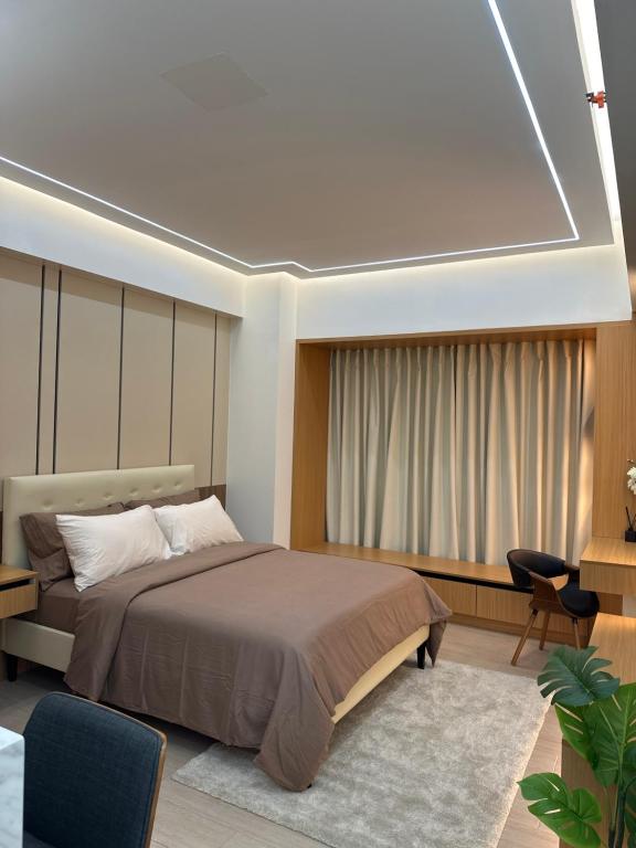 a bedroom with a bed and a large window at Resorts World Eighty One Newport Boulevard Near Airport T2 and T3 in Manila
