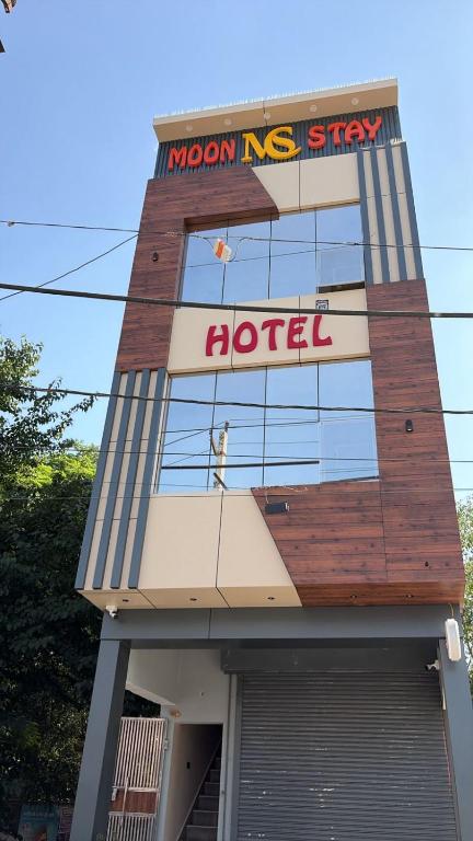 a hotel with a sign on the side of a building at Moon Stays Newly Build I Couple Friendly I Panipat in Pānīpat