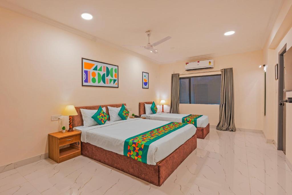 a hotel room with two beds and a window at Treebo GT Meridian, T-Nagar in Chennai