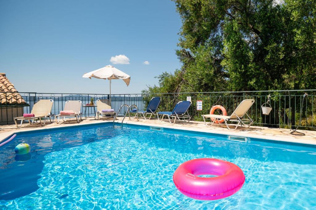 a swimming pool with a red frisbee in the water at SeaView Calypso in Nisaki