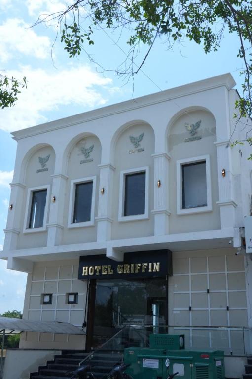 a large white building with a hotelhtarhtar sign on it at Hotel Griffin in Kīratpur