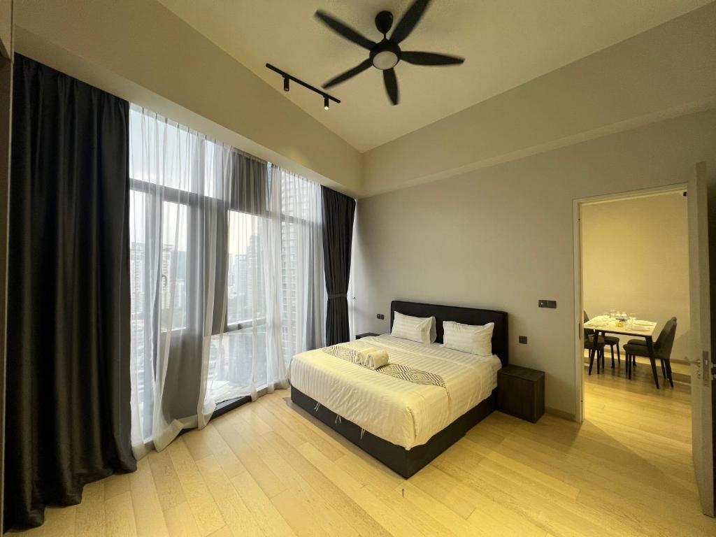 a bedroom with a bed and a ceiling fan at Star Residence KLCC By BluekeyKL in Kuala Lumpur
