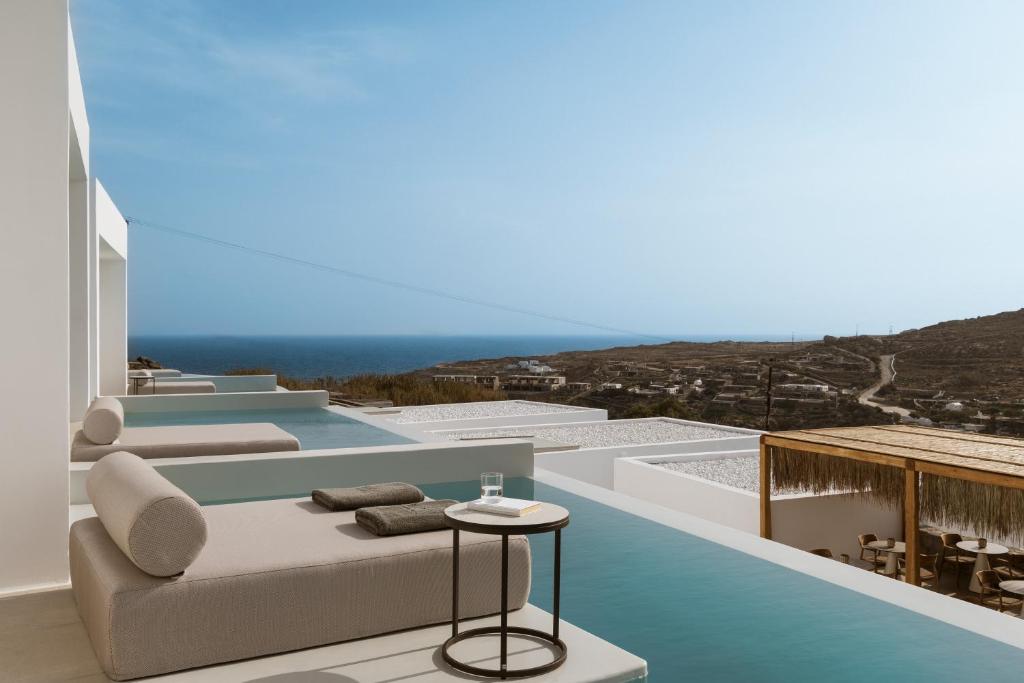 a view of the ocean from the balcony of a house at Mykonos Flow Super Paradise, Adults Only by Mr and Mrs White in Super Paradise Beach