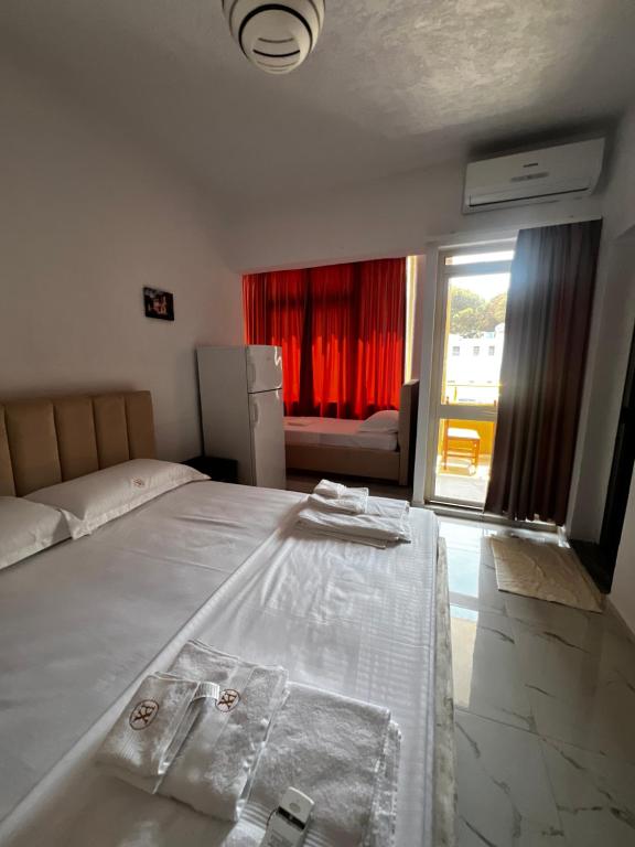 a bedroom with a large bed and a window at ApartHotel XH in Golem