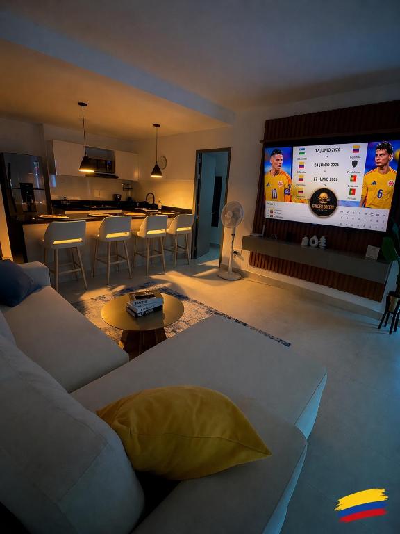 a living room with a couch and a large screen at Golden Breeze in Cartagena de Indias