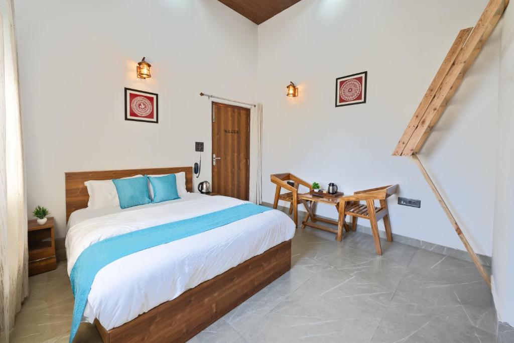 a bedroom with a bed and a wooden table at Kaafal Cottage in Mukteshwar
