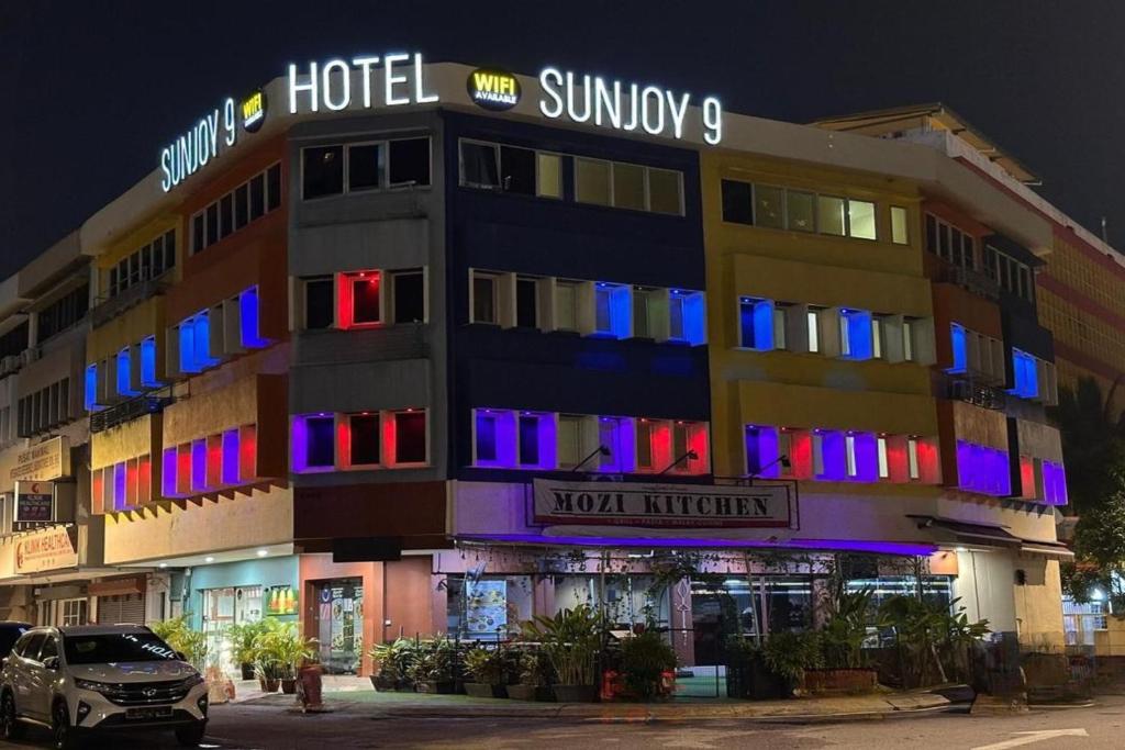 a building with blue and purple lights on it at Hotel Sunjoy9 OKR Near Midvalley 10 Mins Only in Kuala Lumpur