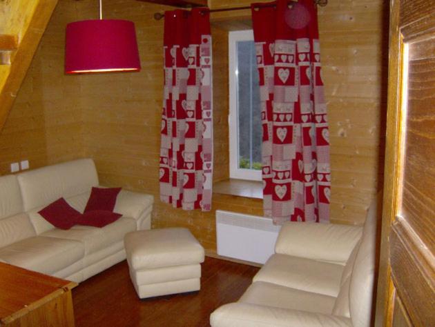 a living room with a white couch and a window at logis des comtes in Bramevaque