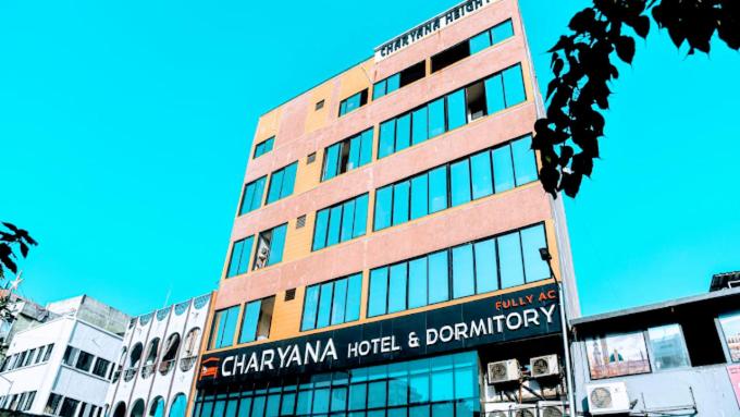 a tall building with a sign on the side of it at Charyana Heights Ac Dormitory in Ahmedabad