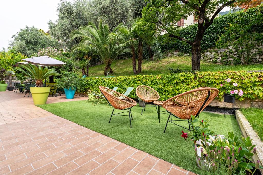 a group of chairs sitting on a lawn at Casa Tuly 1 in Brenzone sul Garda