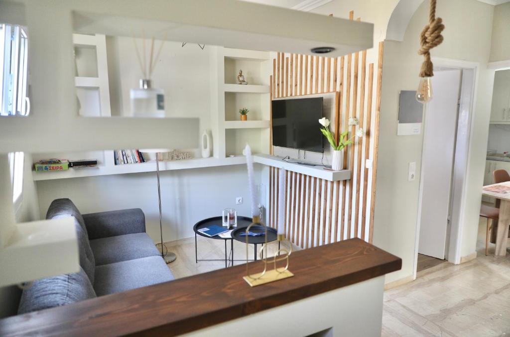 a living room with a couch and a table at Adriana's Summer House in Kassiopi