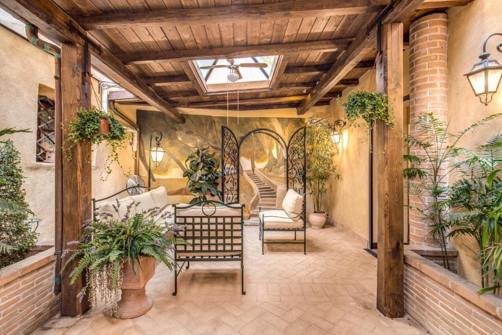 an indoor patio with plants and a skylight at Residenza San Calisto in Rome