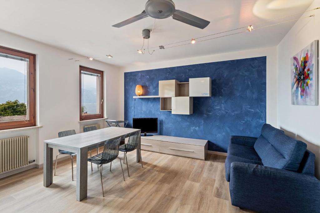 a living room with a table and a blue wall at Casa Tuly in Brenzone sul Garda