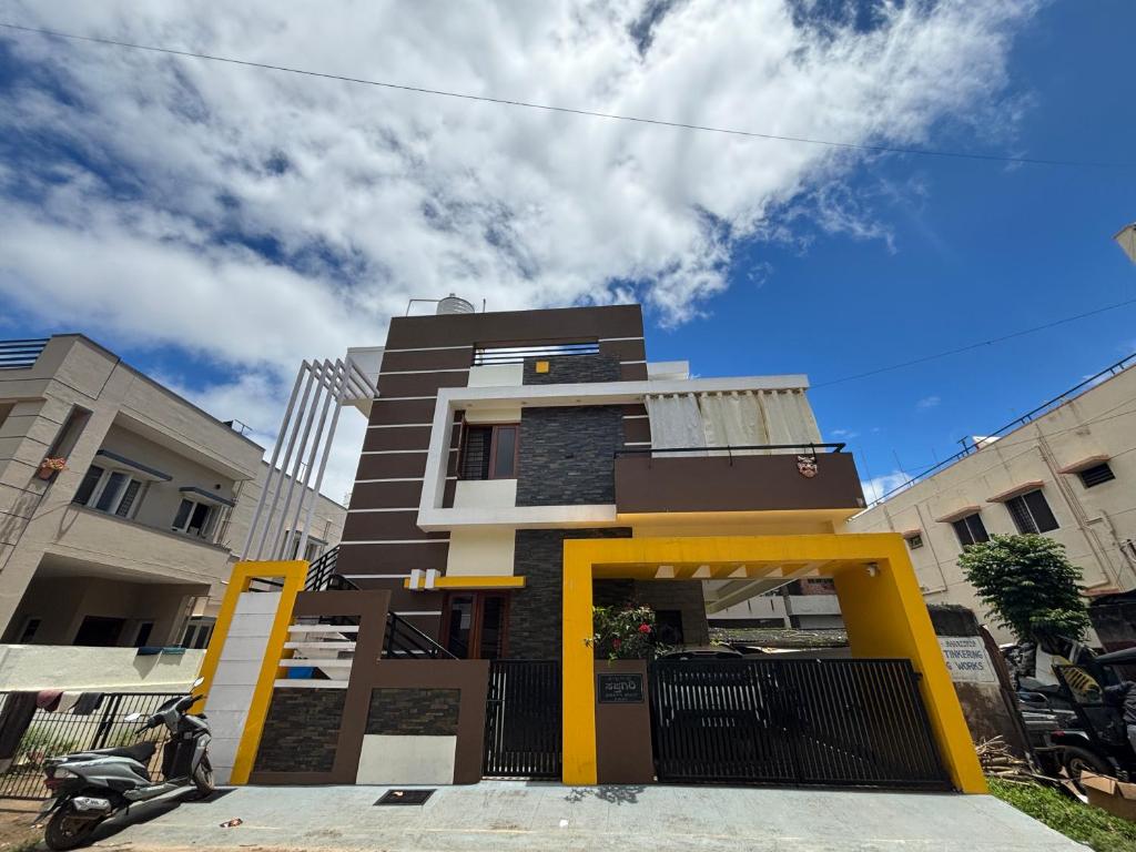 a building with a yellow stand in front of it at Satgiri Nest House in Chikmagalūr