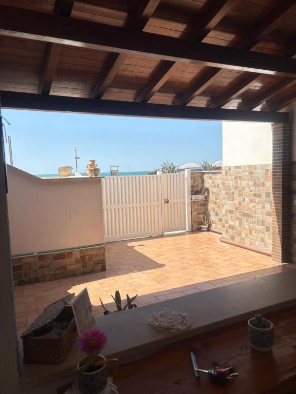 a view of a patio through a large window at Vista mare Fiumicino-Beach&Fly Stay in Fiumicino