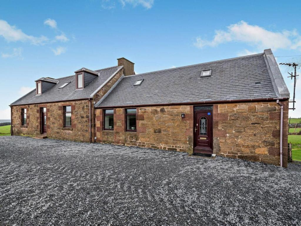 a brick house with a driveway in front of it at 3 Bed in Girvan oc-96394 in Girvan