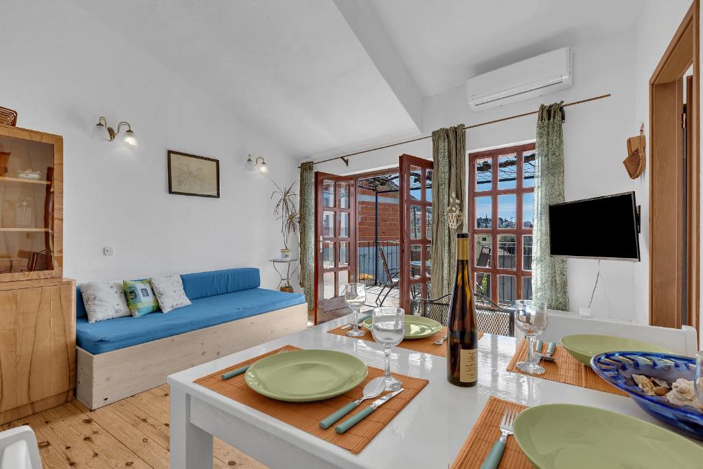 a living room with a blue couch and a table at Authentic Hideaway by Riva with Free Parking in Podgora