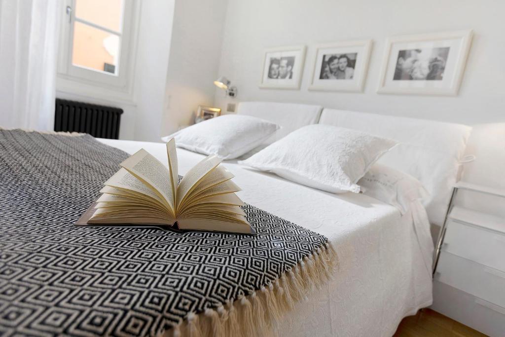 a book sitting on top of a bed at C123 Luxury in Chiavari