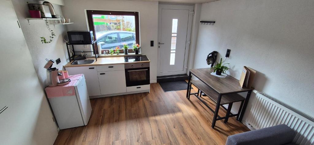a kitchen with a sink and a table in a room at Mitten im Sauerland in Finnentrop