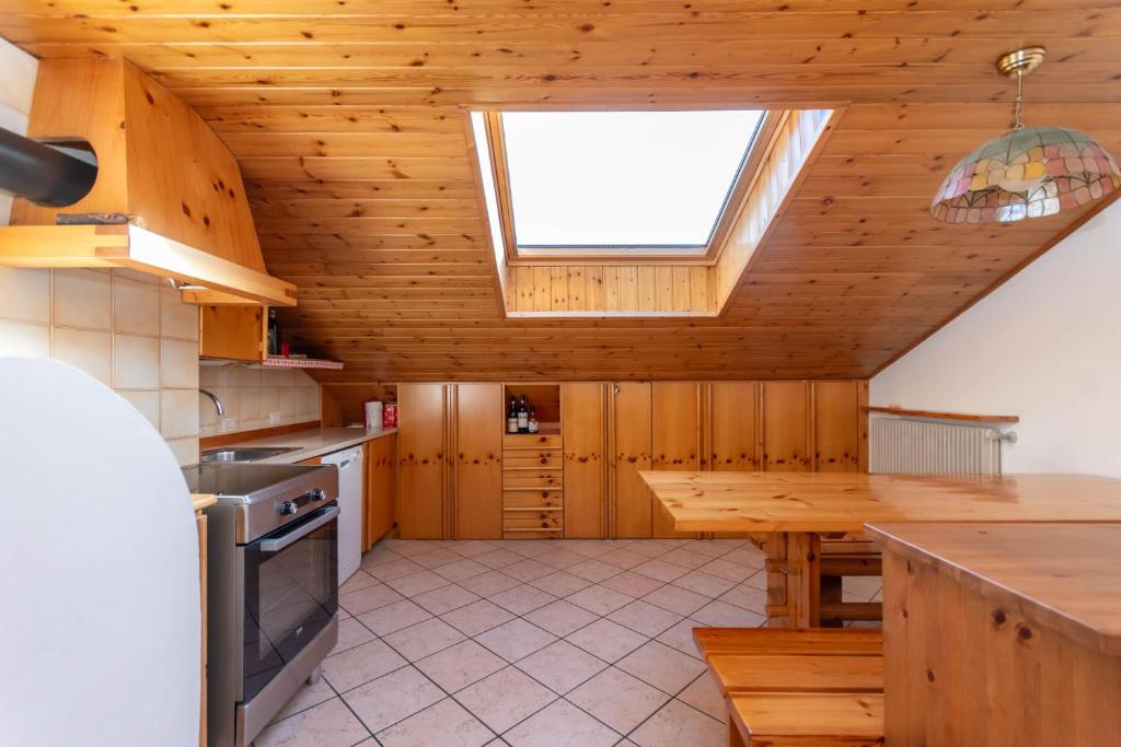 a kitchen with a skylight in a wooden ceiling at Ciasa Gaia in Mazzin