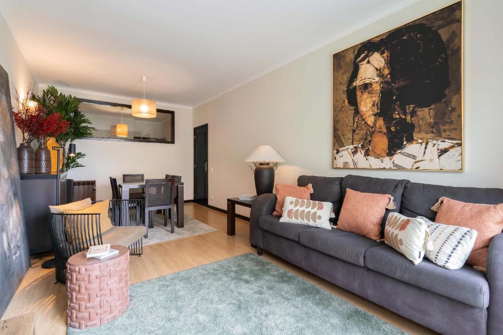 a living room with a couch and a table at Oceanfront Views & Modern Elegance by HostWise in Vila do Conde