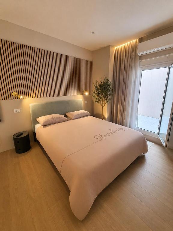 a large bed in a room with a large window at B&B Luna Rossa in Altamura