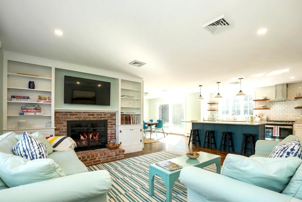 a living room with two white couches and a fireplace at Newly updated home sleeps 7, AC, free WIFI, half mile to town in Chatham