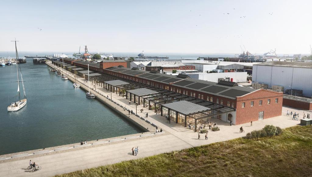 a dock with a marina with a boat in the water at HENRI Hotel Cuxhaven in Cuxhaven