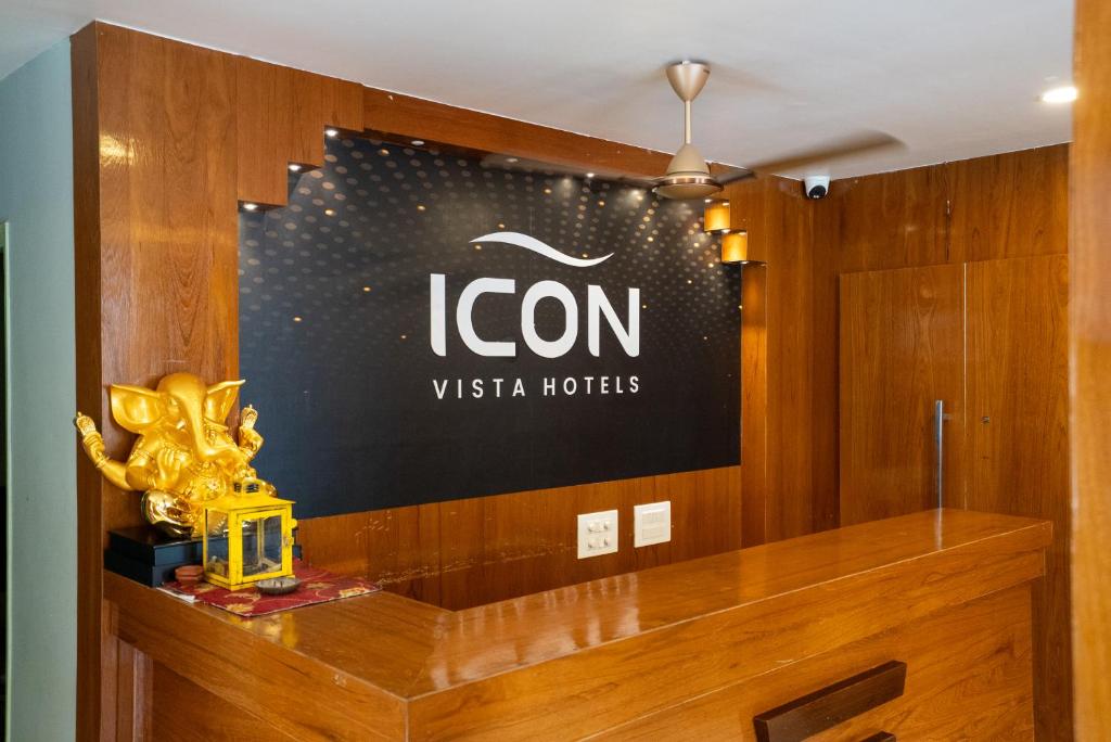 a sign for the icorn vista hotel on a wall at Icon vista hotel in Tirupati