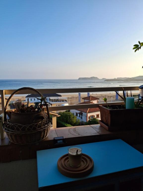 a view of the ocean from a balcony with a basket at Frente al mar, Doña Carmen Playa, Mejor vista de Suances in Suances