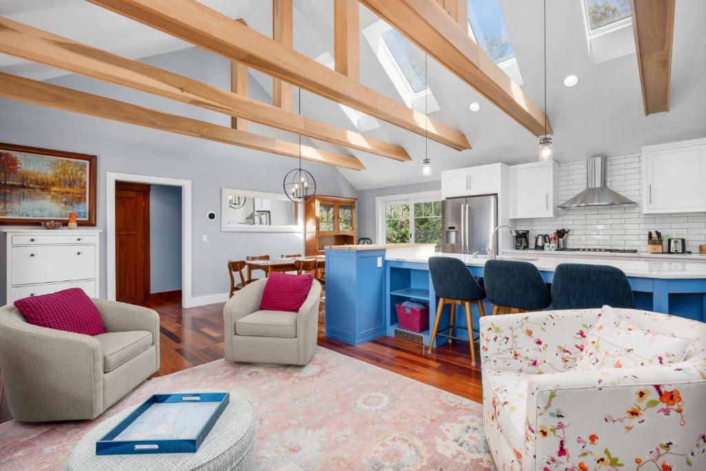 a kitchen and living room with blue cabinets at Gorgeous Cape Cod Retreat Near Town Neck in East Sandwich