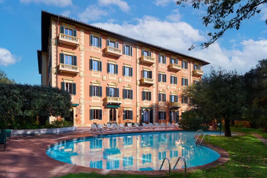 a large building with a pool in front of a building at Grand Hotel Bellavista Palace & Golf in Montecatini Terme