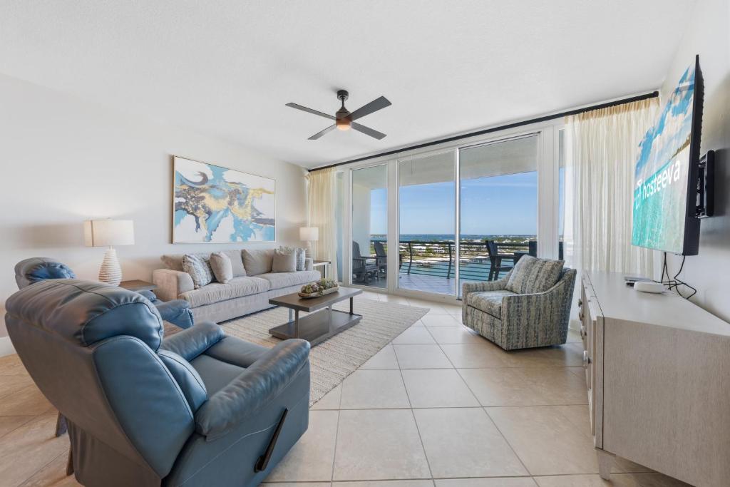 a living room with a couch and a tv at Bella Luna 908 in Orange Beach