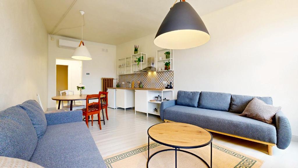 a living room with a blue couch and a table at tARTu Stays 5-3 Spacious Apartment Tartu Old Town in Tartu