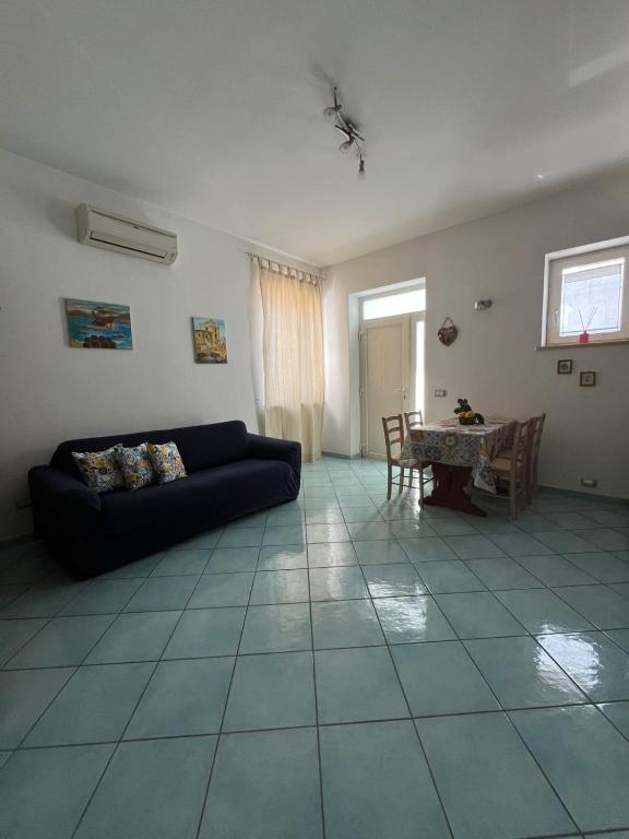 a living room with a couch and a table at La Casetta in Lacco Ameno