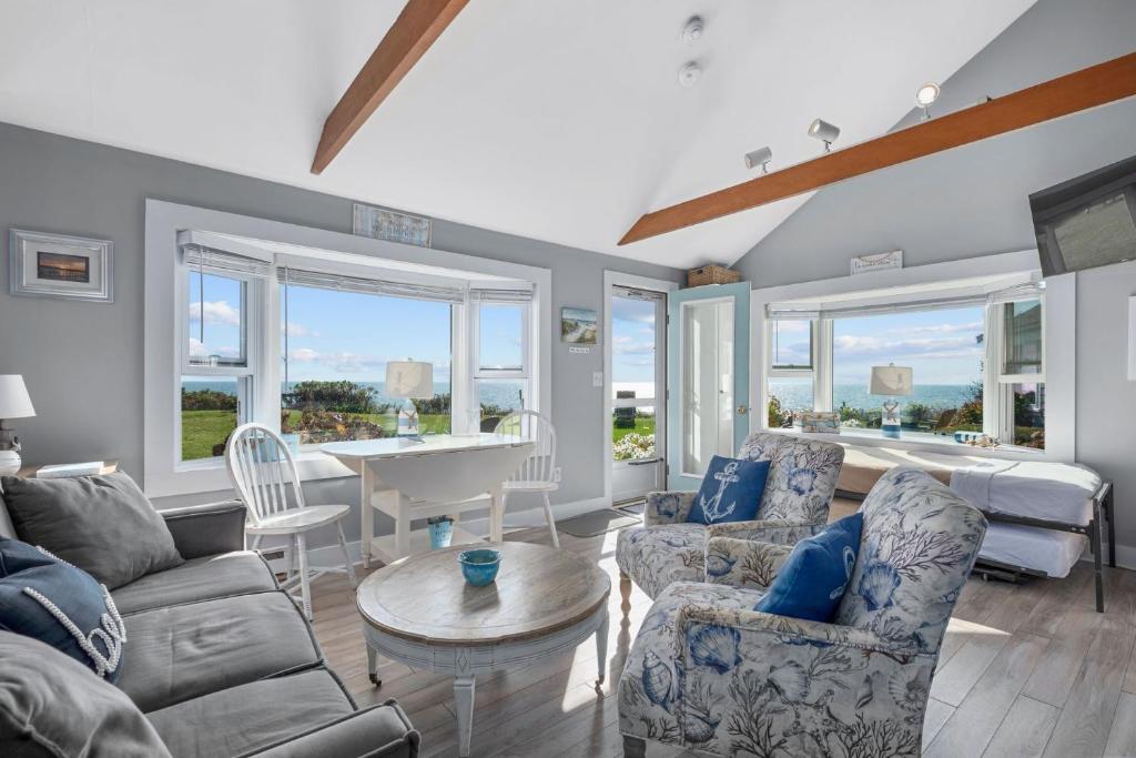 a living room with a couch and chairs and a table at Lost at Seaside – Your Cozy Coastal Hideaway in South Yarmouth