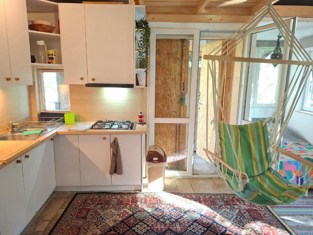 a kitchen with a hammock in the middle of a room at Gomba Kert in Nagymaros