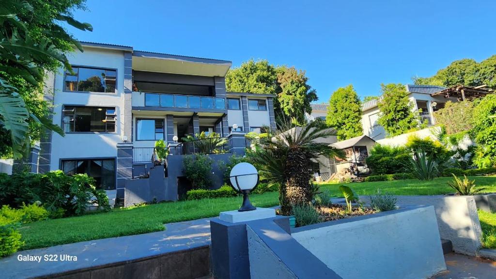 a house with a garden in front of it at The Mansion Lodge in Hartbeespoort