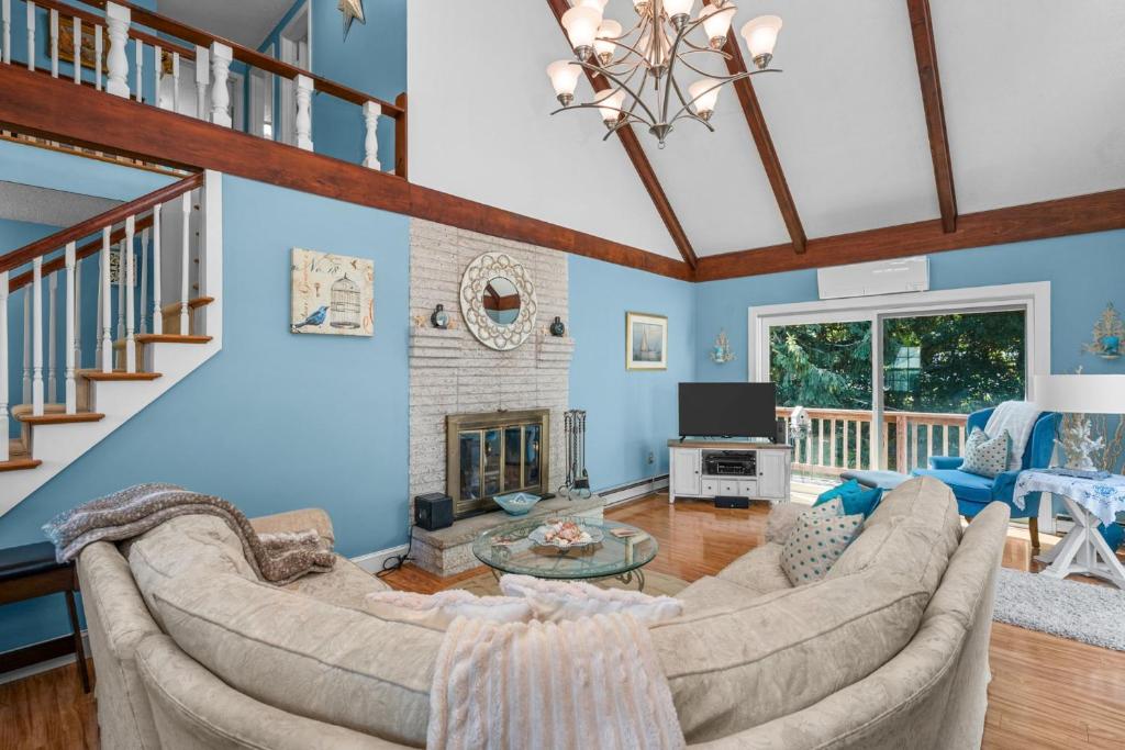 a living room with a couch and a fireplace at Cape Cod Escape – 1 Mile to Beach, A/C Grill in Centerville