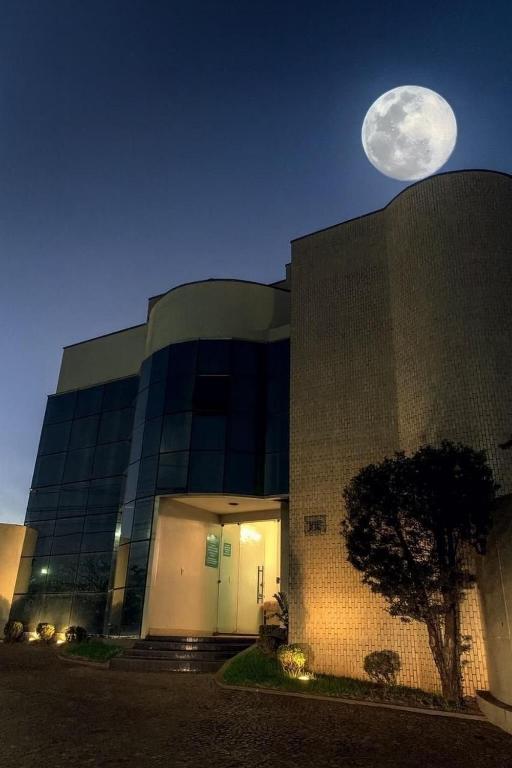 a large building with a full moon in the sky at Oásis Hotel in Araguaína