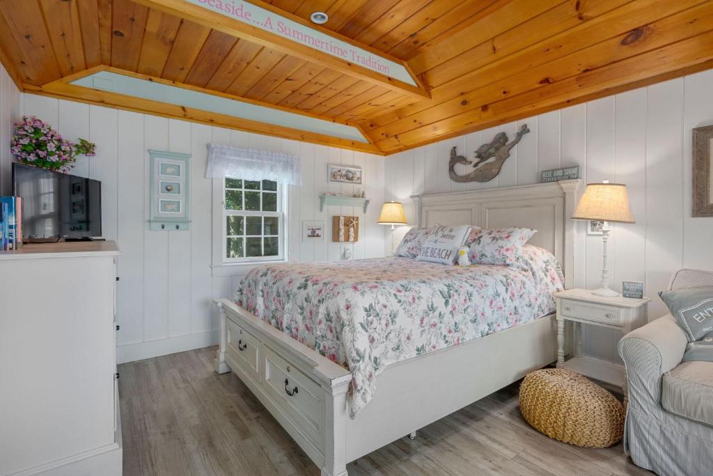 a bedroom with a bed and a wooden ceiling at Seaglass Cottage – Where Calm Meets Tide in South Yarmouth